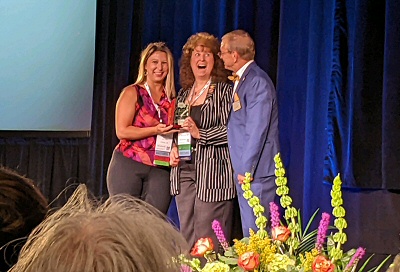 ARSA President Ashley Smith and former ARSA President Cindy Lewis accept the State Assembly Leadership Award from AST President Kevin Craycraft 