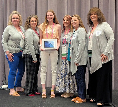 The lucky winner of a donated Android 15 Tablet was Emma Thompson of Indiana. She is shown with members of the ARSA Board.