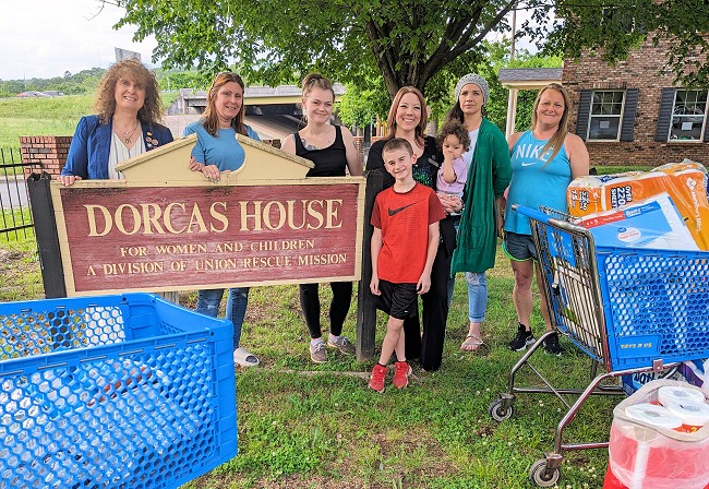 Some of the Dorcas House residents are pictured accepting donations from ARSA Treasurer Cindy Lewis (far left) and Director Kacie Denham (third from right).